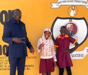 Learners of Chief Hosea Kutako Primary School share a joyful moment during the official handover of a new photocopy machine, joined by Metropolitan Sales Manager Mr. Denias Hangula. 